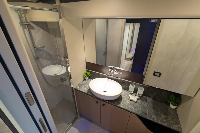  Yacht Photos Pics Luxurious bathroom in 2025 Absolute 52 FLY yacht with modern fixtures and elegant design.