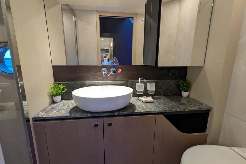  Yacht Photos Pics Luxurious bathroom on 2025 Absolute 52 FLY yacht with modern sink and elegant decor.