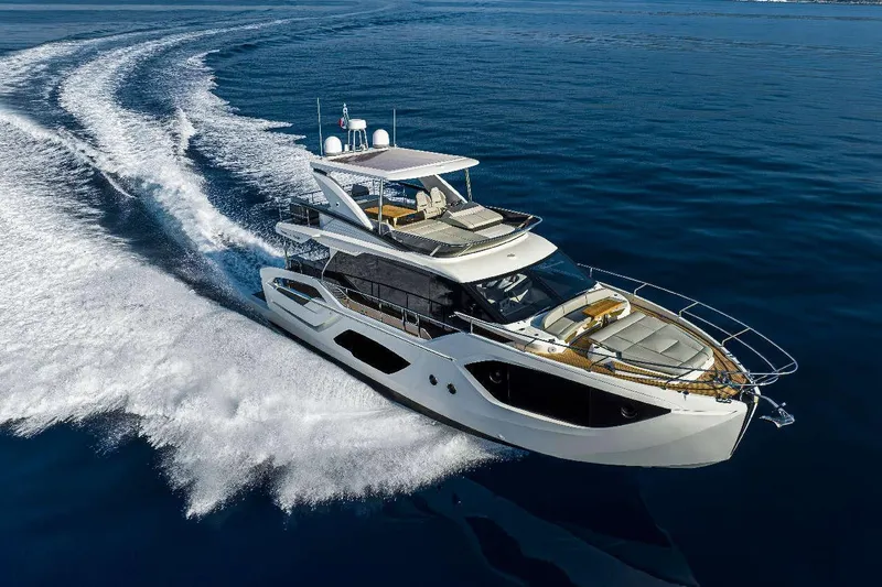  Yacht Photos Pics Luxurious 2025 Absolute 52 FLY yacht cruising on open water.