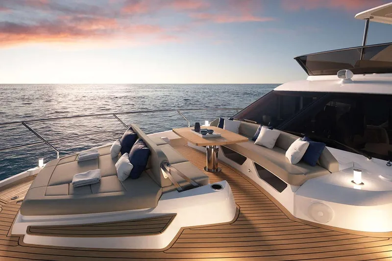  Yacht Photos Pics Luxurious 2025 Absolute 52 FLY yacht deck at sunset, featuring elegant seating and ocean views.