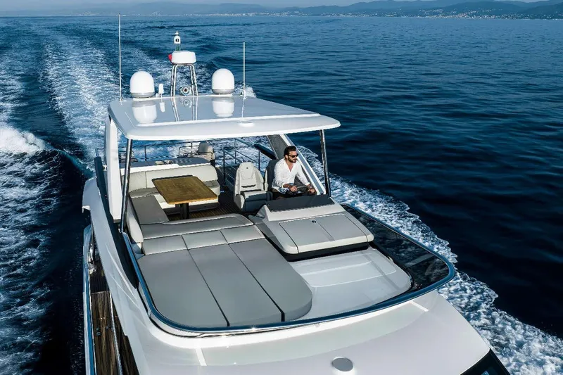  Yacht Photos Pics 2025 Absolute 52 FLY yacht cruising on open water, featuring spacious flybridge.