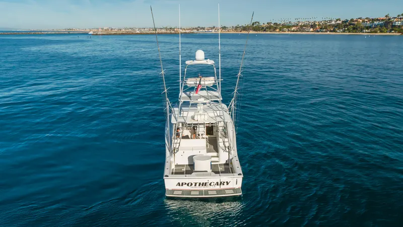 Apothecary Yacht Photos Pics Cabo Express 2011 boat on calm ocean waters, distant coastline in background.