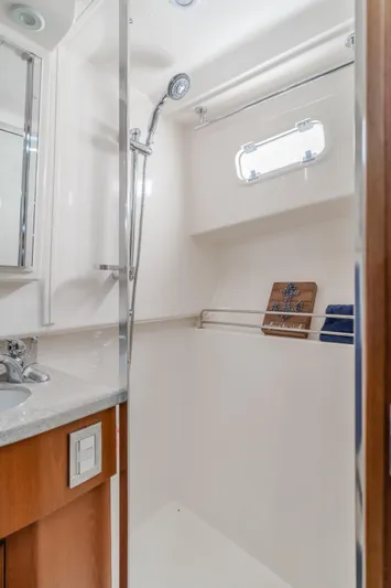 Apothecary Yacht Photos Pics 2011 Cabo Express yacht bathroom with shower, sink, and window.