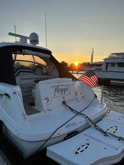  Yacht Photos Pics 2009 Sea Ray 40 Sundancer yacht Maggie docked at sunset with American flag.