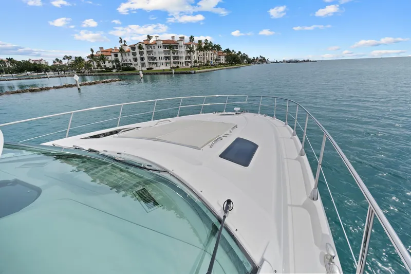 Majestic Stars Yacht Photos Pics 2012 Sea Ray Sundancer 580 yacht cruising near luxury waterfront residences.