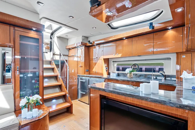 Majestic Stars Yacht Photos Pics Luxurious interior of 2012 Sea Ray Sundancer 580 yacht with modern kitchen and wooden finishes.