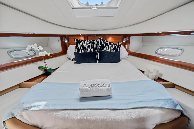 Majestic Stars Yacht Photos Pics Luxurious cabin interior of 2012 Sea Ray Sundancer 580 yacht with elegant bedding and decor.