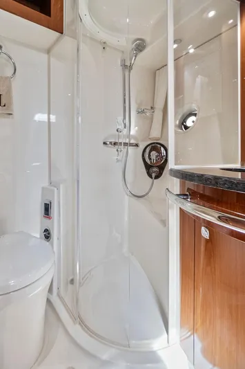 Majestic Stars Yacht Photos Pics Luxurious bathroom in 2012 Sea Ray Sundancer 580 yacht with modern shower and wooden cabinetry.