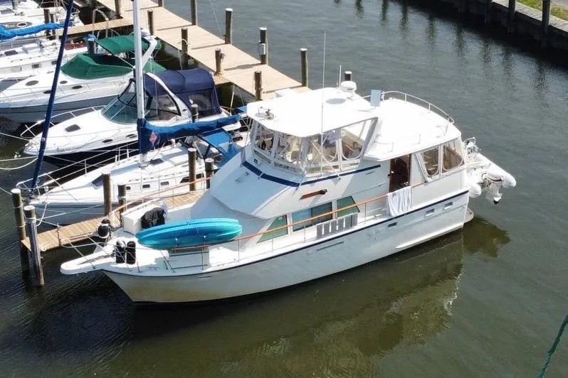 Sea Breeze Yacht Photos Pics 1985 Hatteras 43 Motor Yacht docked in marina, surrounded by other boats.