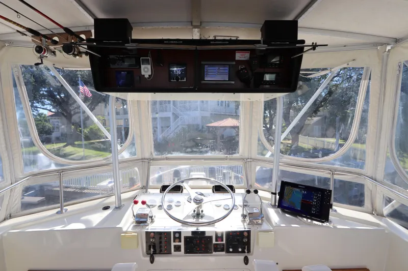 Sea Breeze Yacht Photos Pics 1985 Hatteras 43 Motor Yacht helm with navigation equipment and panoramic windows.