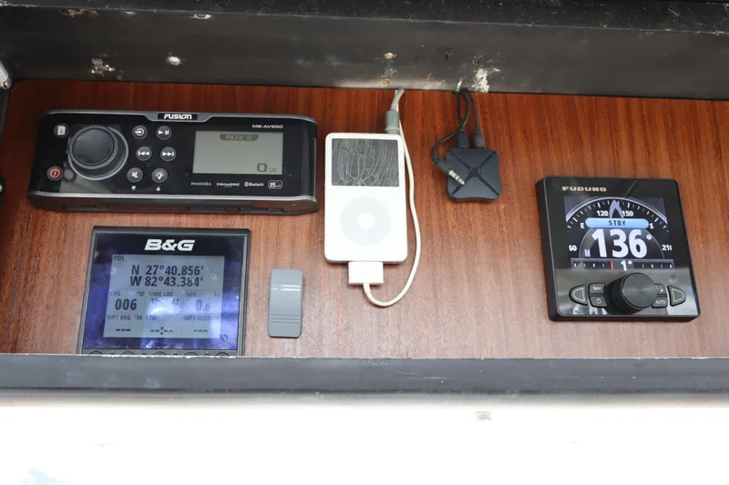 Sea Breeze Yacht Photos Pics Control panel of 1985 Hatteras 43 Motor Yacht with navigation and audio equipment.