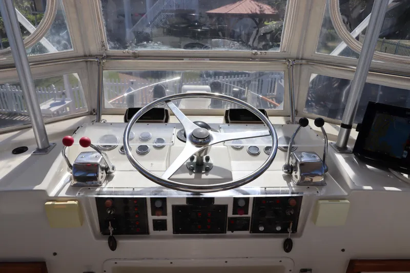 Sea Breeze Yacht Photos Pics Helm of 1985 Hatteras 43 Motor Yacht with steering wheel and controls.