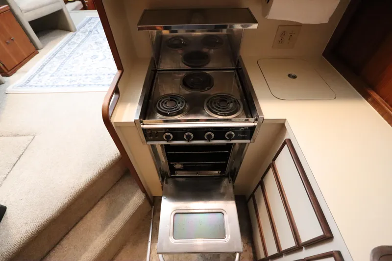 Sea Breeze Yacht Photos Pics Compact kitchen in 1985 Hatteras 43 Motor Yacht with stove and oven.