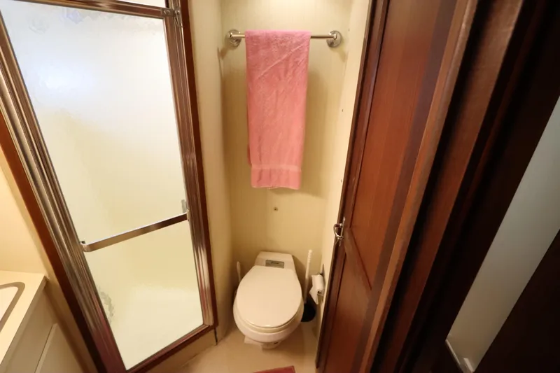 Sea Breeze Yacht Photos Pics Bathroom interior of 1985 Hatteras 43 Motor Yacht with shower and toilet.