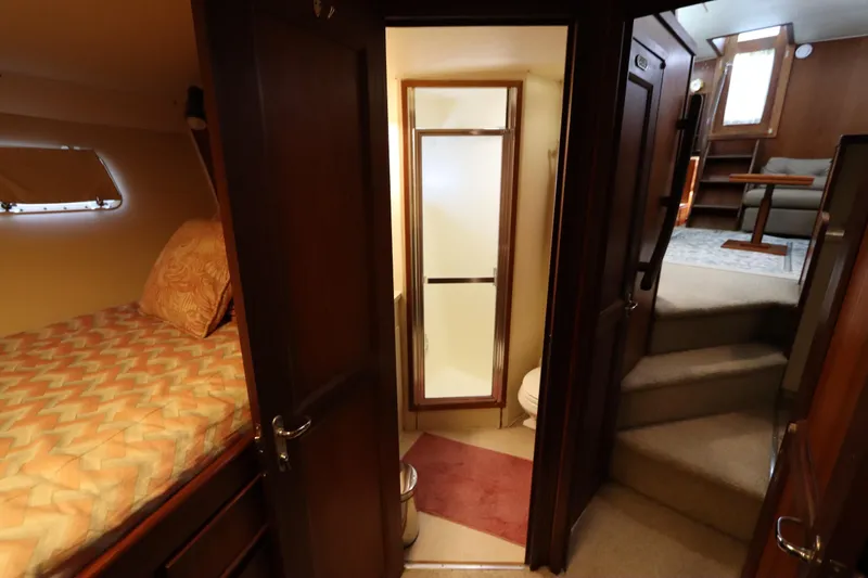 Sea Breeze Yacht Photos Pics 1985 Hatteras 43 Motor Yacht interior with cozy cabin, bathroom, and stairs to living area.
