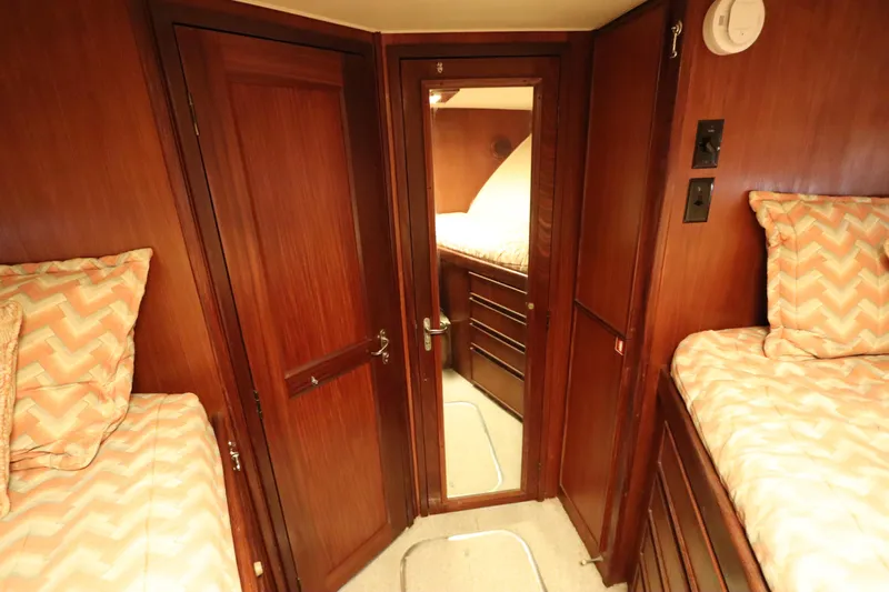 Sea Breeze Yacht Photos Pics Interior of 1985 Hatteras 43 Motor Yacht with wood paneling and twin beds.