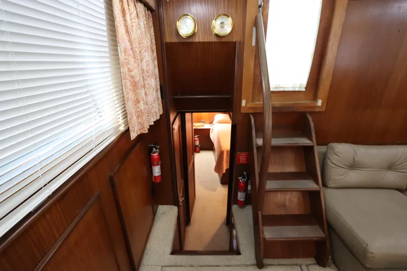 Sea Breeze Yacht Photos Pics Interior of 1985 Hatteras 43 Motor Yacht with wooden stairs and cozy cabin.
