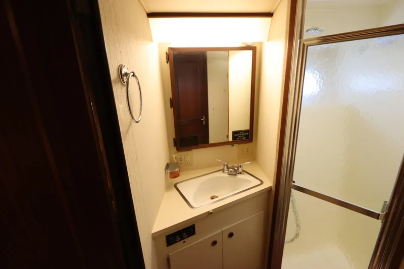 Sea Breeze Yacht Photos Pics Bathroom interior of 1985 Hatteras 43 Motor Yacht with sink and shower.
