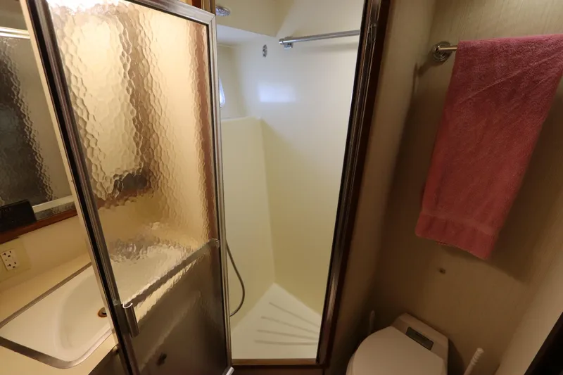 Sea Breeze Yacht Photos Pics Bathroom interior of 1985 Hatteras 43 Motor Yacht with shower and sink.
