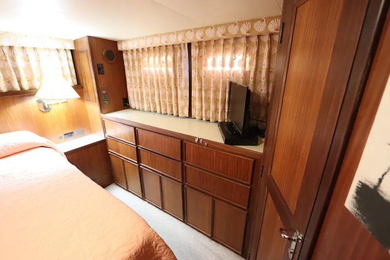 Sea Breeze Yacht Photos Pics Interior of 1985 Hatteras 43 Motor Yacht with wood cabinetry and cozy decor.