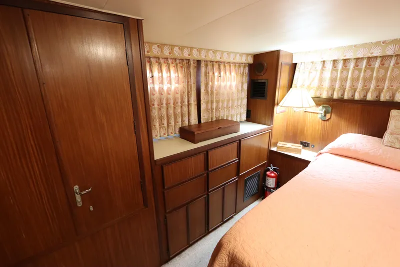 Sea Breeze Yacht Photos Pics 1985 Hatteras 43 Motor Yacht interior with wood cabinetry and cozy bedroom.