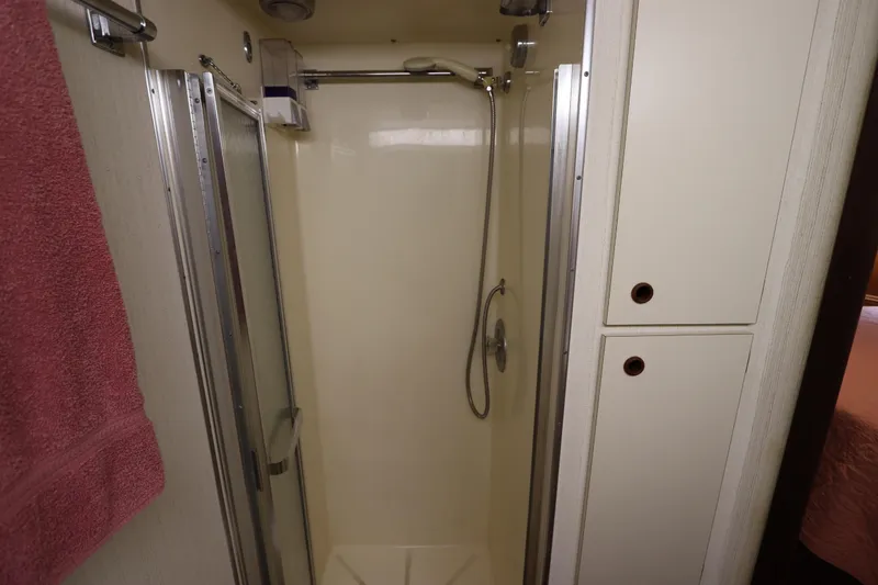 Sea Breeze Yacht Photos Pics Shower area in 1985 Hatteras 43 Motor Yacht with towel and storage cabinets.