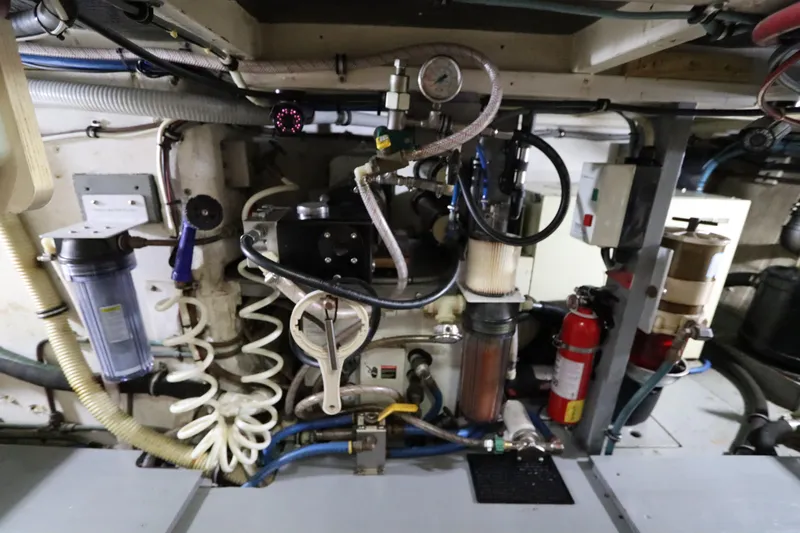 Sea Breeze Yacht Photos Pics Engine room of a 1985 Hatteras 43 Motor Yacht, featuring various mechanical components.
