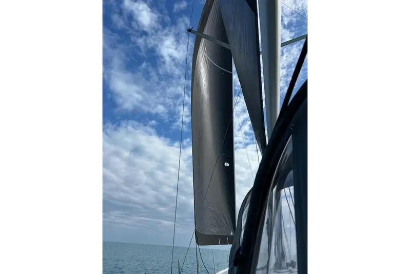 Agua Especial Yacht Photos Pics Sailing on a 2016 Jeanneau 54 yacht with sails unfurled under a partly cloudy sky.