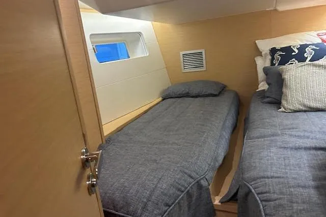 Agua Especial Yacht Photos Pics Cozy cabin interior of 2016 Jeanneau 54 yacht with twin beds and nautical decor.