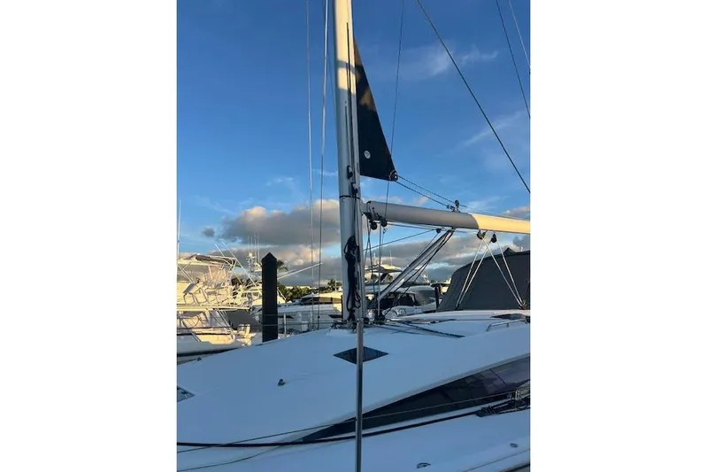 Agua Especial Yacht Photos Pics 2016 Jeanneau 54 sailboat mast against a clear blue sky at marina.