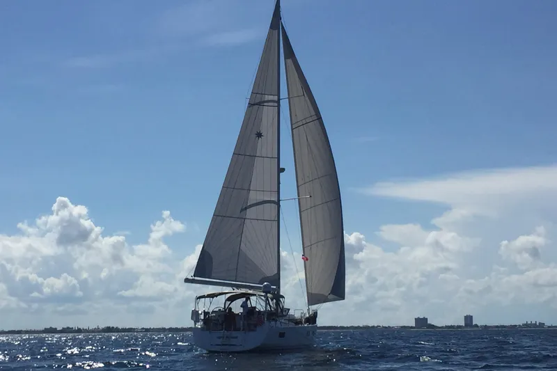 Agua Especial Yacht Photos Pics Sailing yacht Jeanneau 54 (2016) on open sea under clear blue sky.