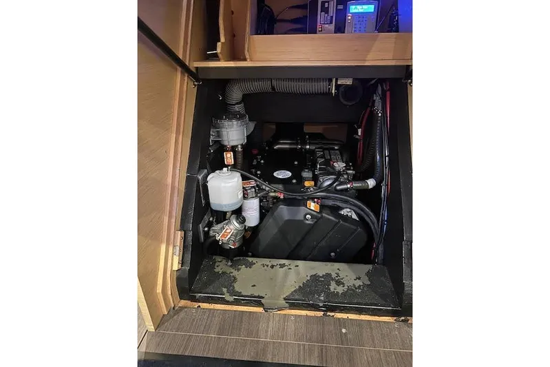 Agua Especial Yacht Photos Pics Engine compartment of a 2016 Jeanneau 54 sailboat, showcasing mechanical components and wiring.
