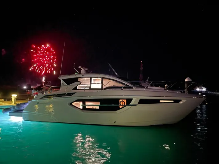 Truly Ineffable Yacht Photos Pics 2019 Cruisers Yachts 42 Cantius at night with fireworks in the background.