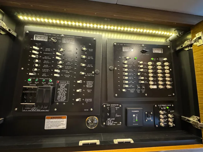 Truly Ineffable Yacht Photos Pics Electrical control panel of 2019 Cruisers Yachts 42 Cantius, illuminated with LED lighting.