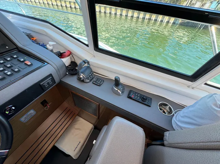 Truly Ineffable Yacht Photos Pics Interior helm of 2019 Cruisers Yachts 42 Cantius with control panel and water view.
