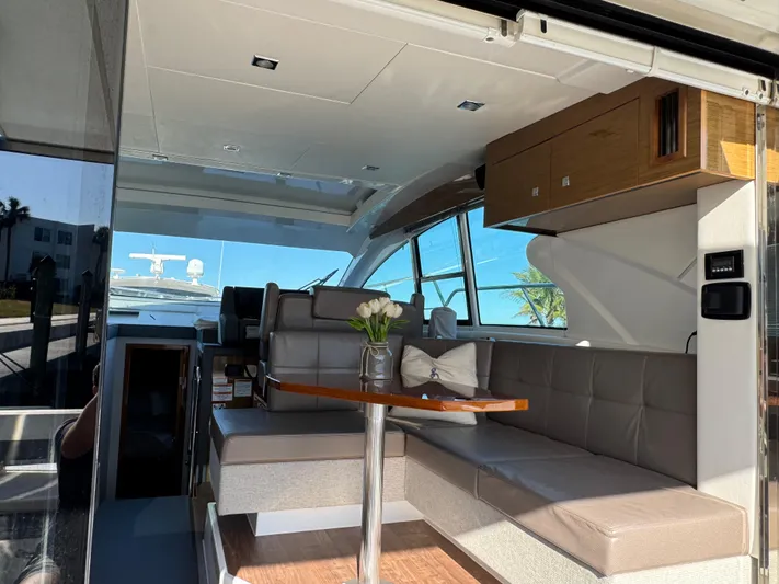 Truly Ineffable Yacht Photos Pics Luxurious interior of 2019 Cruisers Yachts 42 Cantius with modern seating and table.