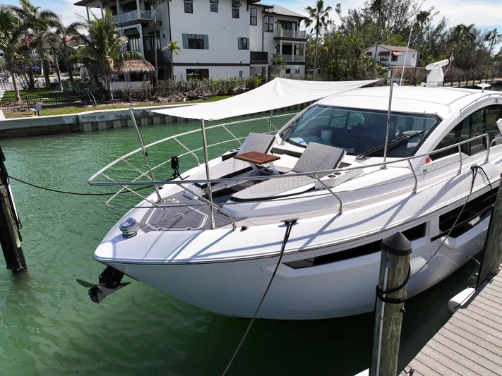 Truly Ineffable Yacht Photos Pics 2019 Cruisers Yachts 42 Cantius docked in a scenic marina setting.