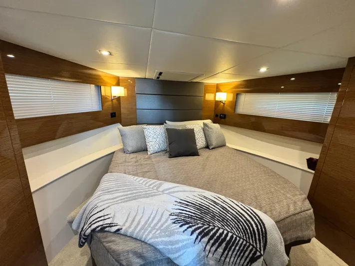 Truly Ineffable Yacht Photos Pics Luxurious bedroom interior of 2019 Cruisers Yachts 42 Cantius with modern decor and cozy lighting.