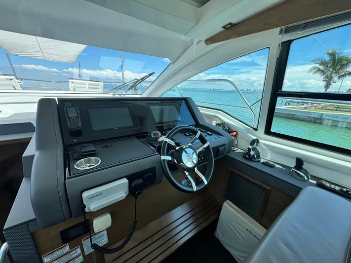 Truly Ineffable Yacht Photos Pics Helm of 2019 Cruisers Yachts 42 Cantius with modern controls and ocean view.