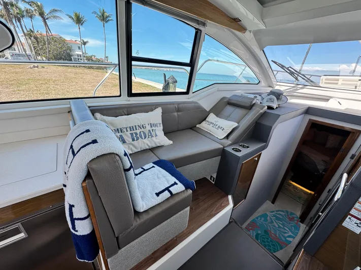 Truly Ineffable Yacht Photos Pics Interior of 2019 Cruisers Yachts 42 Cantius with cozy seating and nautical decor.