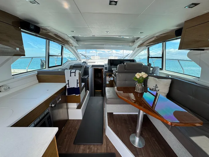 Truly Ineffable Yacht Photos Pics Luxurious interior of 2019 Cruisers Yachts 42 Cantius with elegant seating and ocean view.