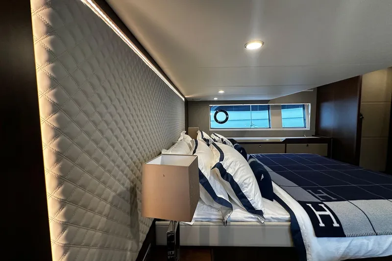  Yacht Photos Pics Luxurious 2023 Fairline Squadron 50 yacht bedroom with elegant bedding and modern lighting.
