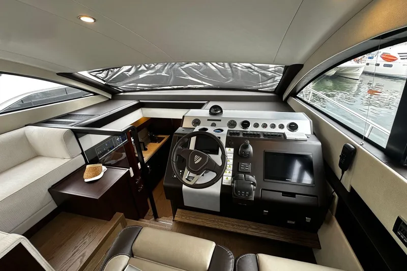  Yacht Photos Pics Interior of 2023 Fairline Squadron 50 yacht, featuring modern helm and luxurious seating.