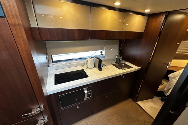  Yacht Photos Pics Luxurious 2023 Fairline Squadron 50 yacht kitchen with modern appliances and sleek cabinetry.