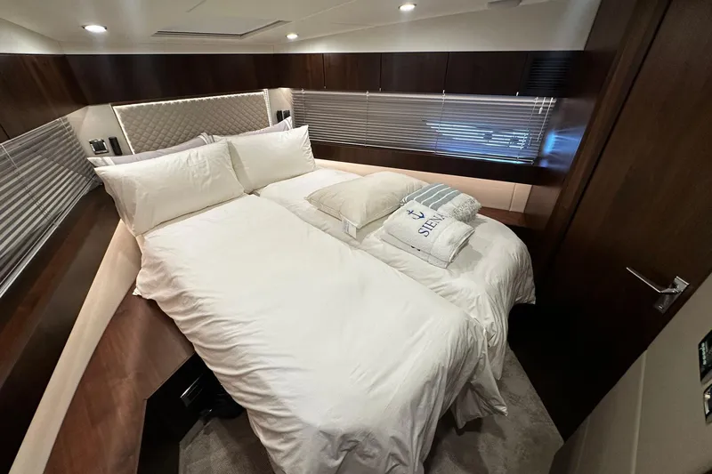  Yacht Photos Pics Luxurious bedroom interior of 2023 Fairline Squadron 50 yacht with elegant bedding.