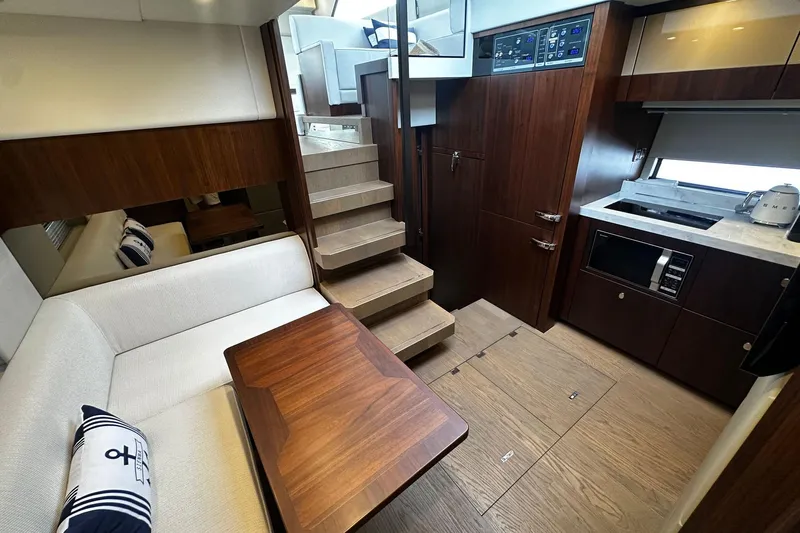  Yacht Photos Pics Luxurious interior of 2023 Fairline Squadron 50 yacht with modern kitchen and seating area.