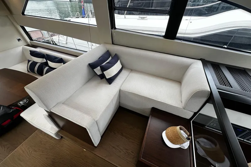  Yacht Photos Pics Luxurious interior of 2023 Fairline Squadron 50 yacht with elegant seating and nautical decor.