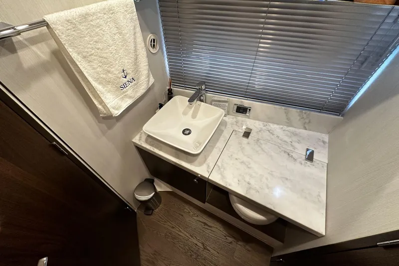  Yacht Photos Pics Luxurious bathroom in 2023 Fairline Squadron 50 yacht with marble countertop and modern sink.