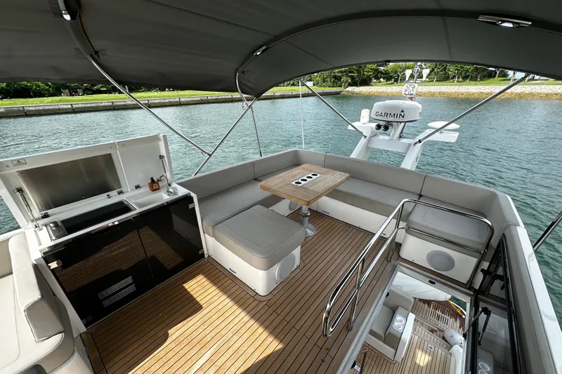  Yacht Photos Pics 2023 Fairline Squadron 50 yacht deck with seating, table, and Garmin equipment.