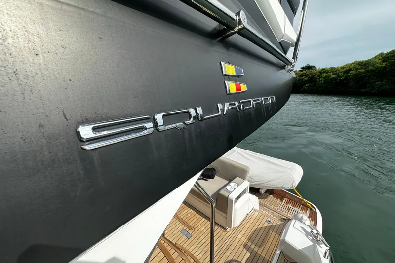  Yacht Photos Pics 2023 Fairline Squadron 50 yacht, side view with logo, docked on calm water.